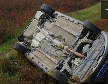 CAR OVERTURNED INTO A DITCH